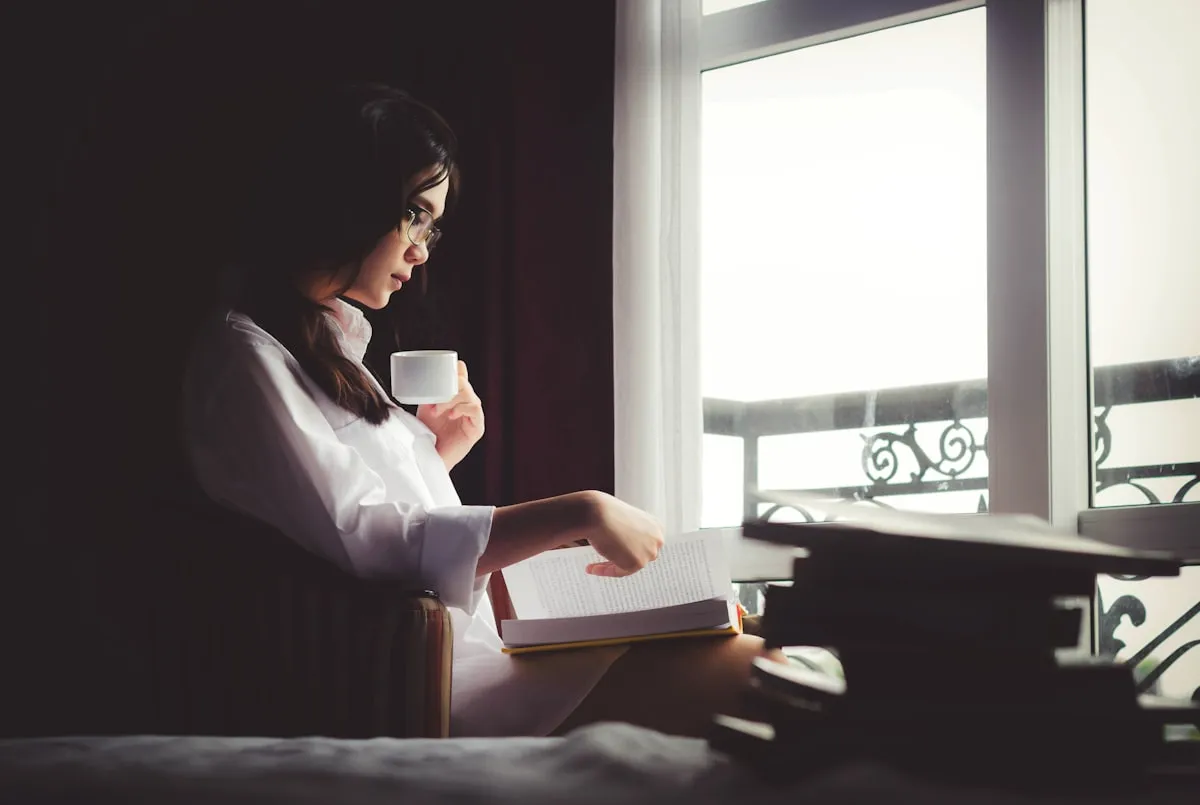 Woman holding a warm mug in soft morning light