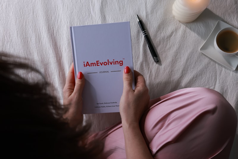 Woman reading a journal with a pen and coffee