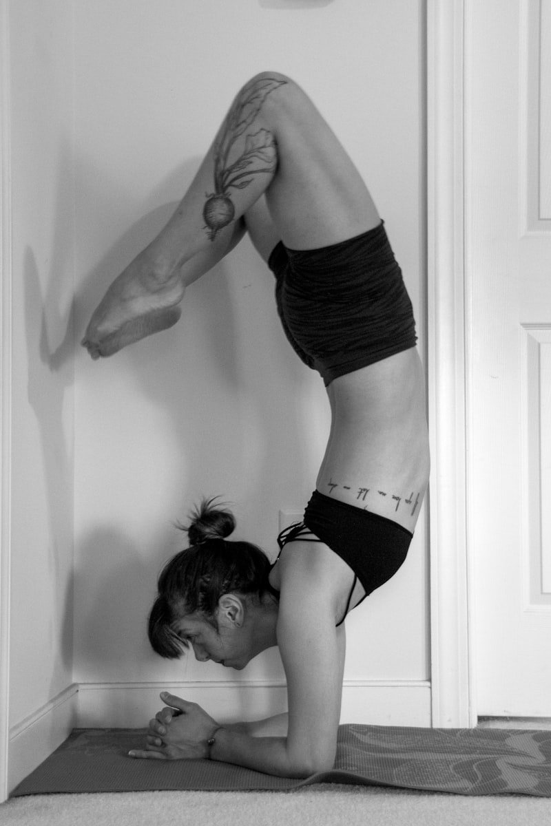 Woman practicing a standing forward fold yoga pose